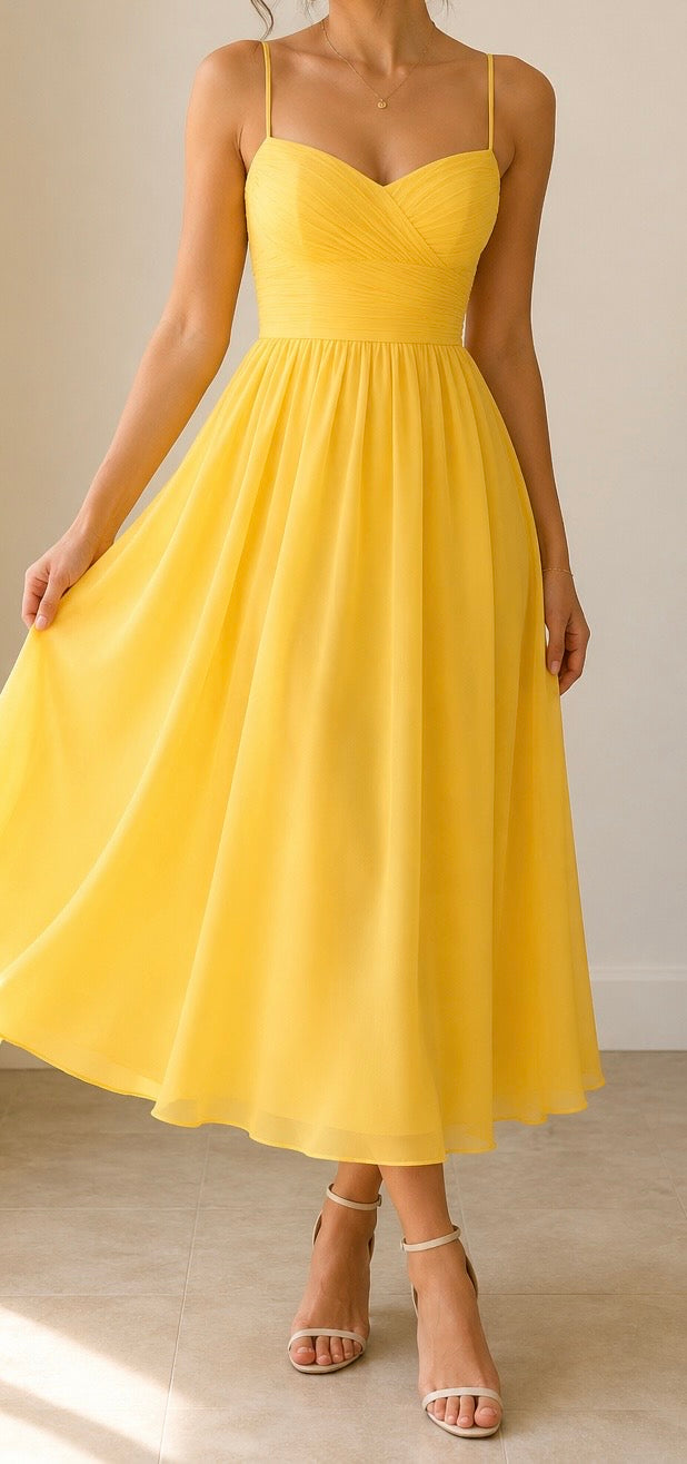 Yellow dress worn by a person on a neutral background