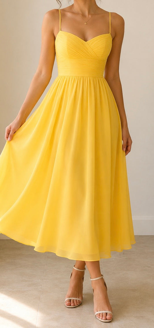 Yellow dress worn by a person on a neutral background
